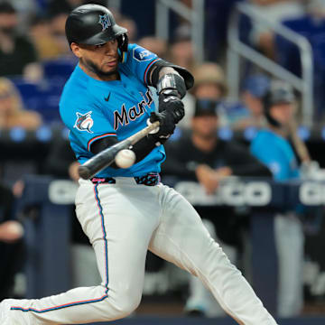 Jul 20, 2025; Miami, Florida, USA; Miami Marlins catcher Agustin Ramirez (50) hits a single against the Kansas City Royals during the first inning at loanDepot Park. Mandatory Credit: Sam Navarro-Imagn Images