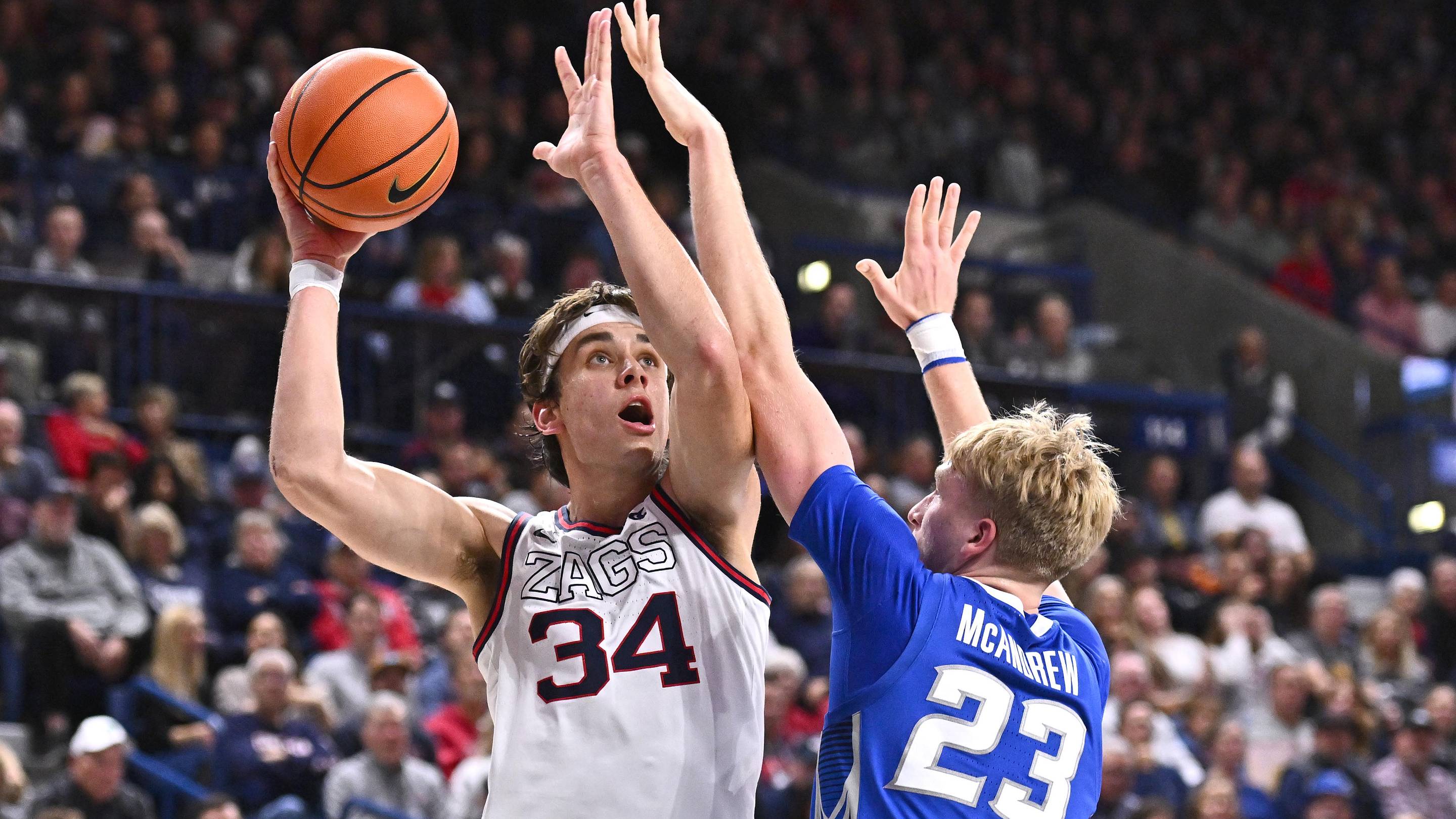 Nov 11, 2025; Spokane, Washington, USA; Gonzaga Bulldogs forward Braden Huff (34) shoots the ball against Creighton Bluejays forward Jackson McAndrew (23) in the second half at McCarthey Athletic Center. Gonzaga Bulldogs won 90-63.