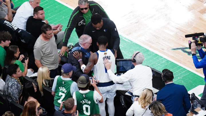 Jun 17, 2024; Boston, Massachusetts, USA; Dallas Mavericks guard Kyrie Irving (11) reacts after colliding with the media bench in the second quarter against the Boston Celtics during game five of the 2024 NBA Finals at TD Garden. Mandatory Credit: David Butler II-USA TODAY Sports