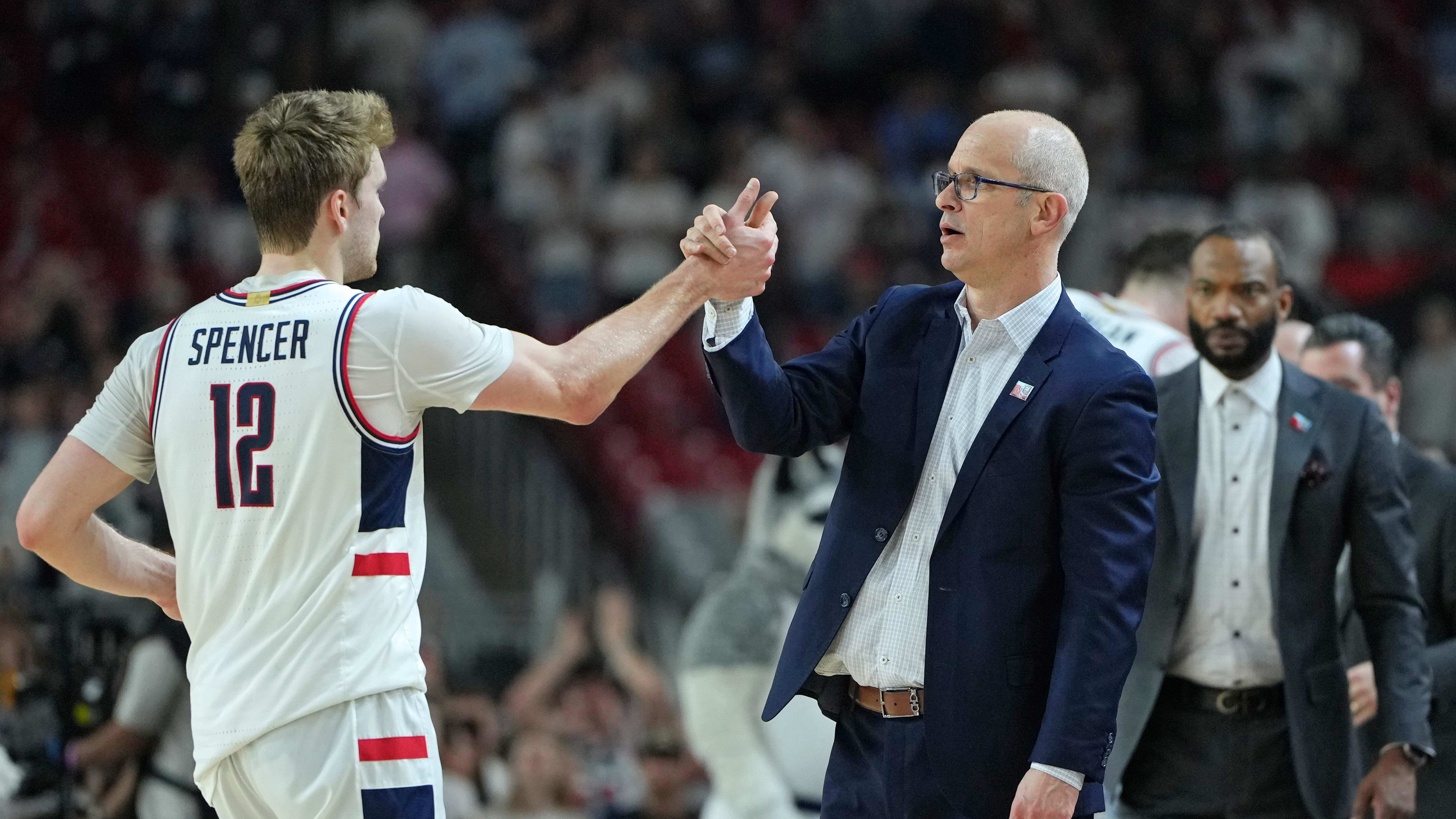  Connecticut coach Dan Hurley high fives guard Cam Spencer.