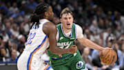 Oct 27, 2025; Dallas, Texas, USA; Dallas Mavericks forward Cooper Flagg (32) is fouled by Oklahoma City Thunder guard Cason Wallace (22) during the second half at the American Airlines Center.