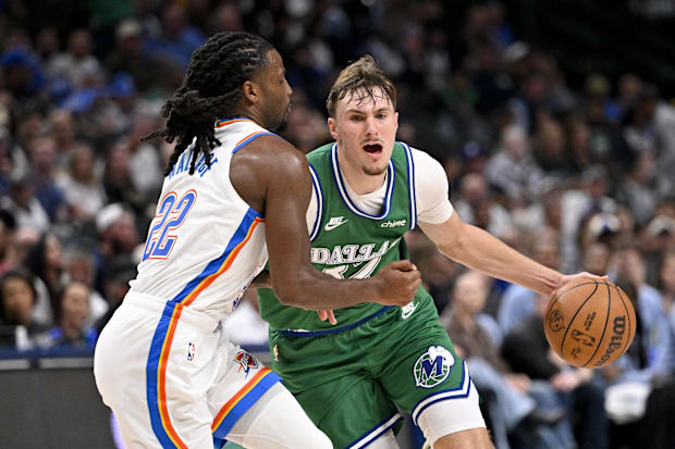 Mavericks forward Cooper Flagg is fouled by Thunder guard Cason Wallace.