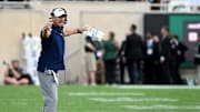 Aug 30, 2024; East Lansing, Michigan, USA;  Florida Atlantic Owls head coach Tom Herman waves his arms contesting a call in the first quarter against the Michigan State Spartans at Spartan Stadium. Mandatory Credit: Dale Young-Imagn Images