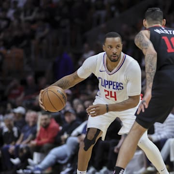 Feb 4, 2024; Miami, Florida, USA; LA Clippers guard Norman Powell (24) dribbles the basketball as Miami Heat forward Caleb Martin (16) defends during the fourth quarter at Kaseya Center. Mandatory Credit: Sam Navarro-Imagn Images