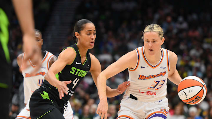 Aug 17, 2025; Seattle, Washington, USA; Phoenix Mercury guard Sami Whitcomb (33) plays the ball while guarded by Seattle Storm guard Skylar Diggins (4) during the first half at Climate Pledge Arena. Mandatory Credit: Steven Bisig-Imagn Images