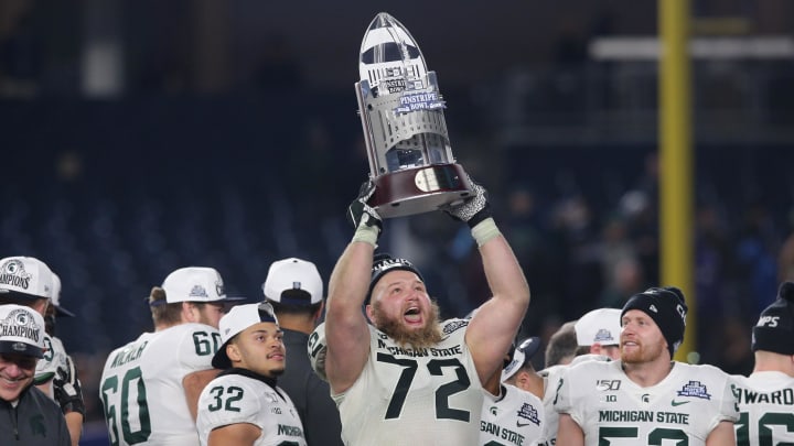 Dec 27, 2019; Bronx, New York, USA; Michigan State defensive tackle Mike Panasiuk (72) celebrates with the trophy after defeating the Wake Forest Demon Deacons in the Pinstripe Bowl at Yankee Stadium. Mandatory Credit: Brad Penner-USA TODAY Sports