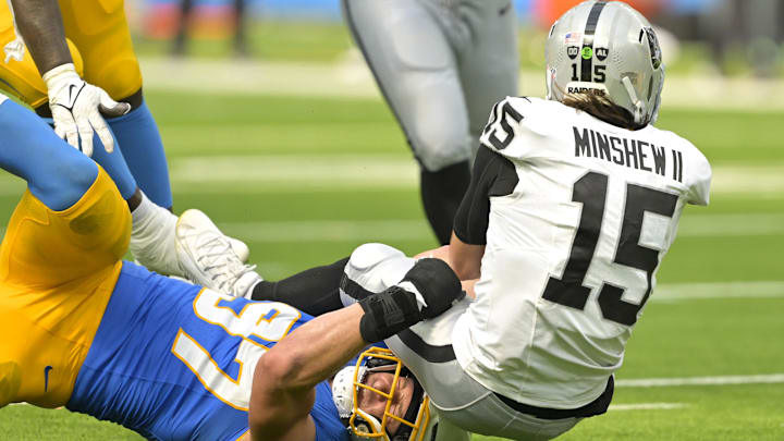 Sep 8, 2024; Inglewood, California, USA; Las Vegas Raiders quarterback Gardner Minshew (15) is sacked by Los Angeles Chargers linebacker Joey Bosa (97) in the second half at SoFi Stadium. Mandatory Credit: Jayne Kamin-Oncea-Imagn Images