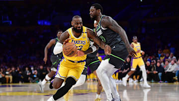 Los Angeles Lakers forward LeBron James drives against Minnesota Timberwolves star Julius Randle during the 2025 NBA Playoffs