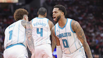 Oct 23, 2024; Houston, Texas, USA; Charlotte Hornets forward Miles Bridges (0) celebrates with guard LaMelo Ball (1) after scoring a basket during the fourth quarter against the Houston Rockets at Toyota Center. Mandatory Credit: Troy Taormina-Imagn Images