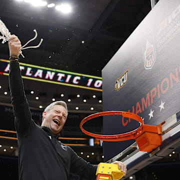 Mar 16, 2025; Washington, D.C., USA; VCU Rams head coach Ryan Odom celebrates after cutting down the net during the championship trophy ceremony after the Rams game against the George Mason Patriots at Capital One Arena. Mandatory Credit: Geoff Burke-Imagn Images