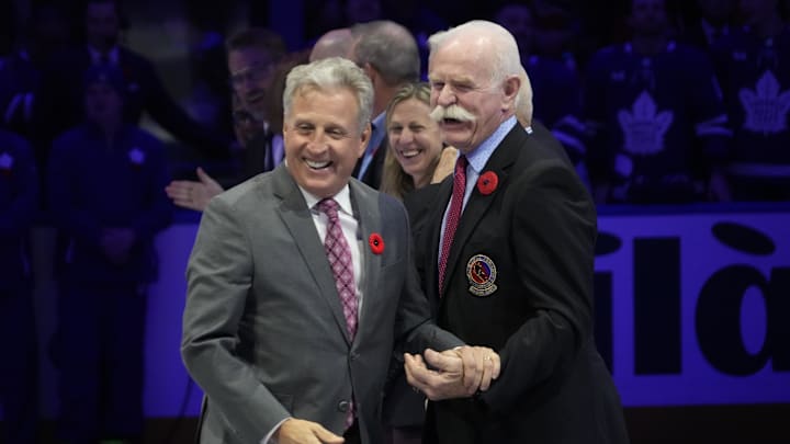 Nov 10, 2023; Toronto, Ontario, CAN; Hockey Hall of Fame inductee Mike Veron (left) laughs with former teammate and Hall of Fame member Lanny McDonald (right) before a game between the Calgary Flames and Toronto Maple Leafs during the first period at Scotiabank Arena. Mandatory Credit: John E. Sokolowski-Imagn Images