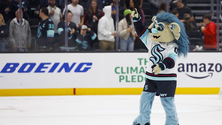 Oct 1, 2022; Seattle, Washington, USA; Seattle Kraken mascot Buoy celebrates on the ice following a 4-0 victory against the Vancouver Canucks at Climate Pledge Arena. Mandatory Credit: Joe Nicholson-Imagn Images