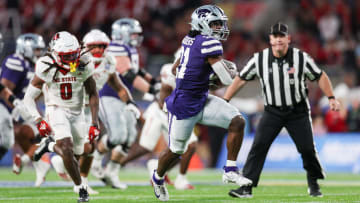 Dec 28, 2023; Orlando, FL, USA;  Kansas State Wildcats running back DJ Giddens (31) runs a pass into the end zone for a touchdown against the North Carolina State Wolfpack in the first quarter during the Pop-Tarts Bowl at Camping World Stadium. Mandatory Credit: Nathan Ray Seebeck-USA TODAY Sports