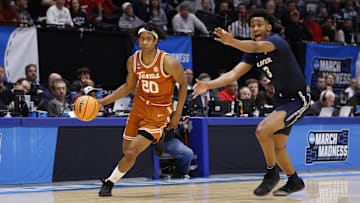 Mar 19, 2025; Dayton, OH, USA; Texas Longhorns guard Tre Johnson (20) dribbles pressured by Xavier Musketeers guard Dailyn Swain (3) in the first half at UD Arena. Mandatory Credit: Rick Osentoski-Imagn Images