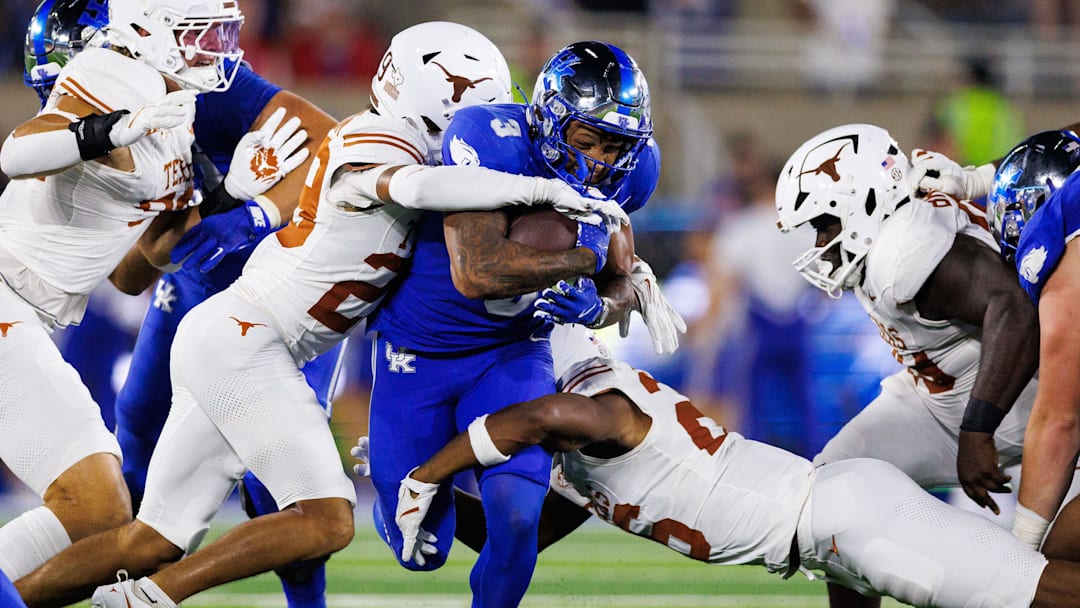 Oct 18, 2025; Lexington, Kentucky, USA; Kentucky Wildcats running back Seth McGowan (3) carries the ball against Texas Longhorns defensive back Graceson Littleton (29) and linebacker Ty'Anthony Smith (26) during the second quarter at Kroger Field. Mandatory Credit: Jordan Prather-Imagn Images