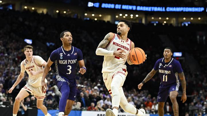 Mar 19, 2026; Portland, OR, USA; Wisconsin Badgers guard Nick Boyd (2) drives to the basket against High Point Panthers guard Rob Martin (3) during the second half of a first round game of the men's 2026 NCAA Tournament at Moda Center. Mandatory Credit: Troy Wayrynen-Imagn Images