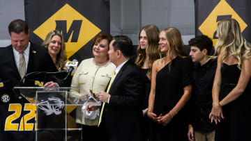Holding a Mizzou jersey gifted by the UM System President, new Missouri athletic director Laird Veatch stands on stage with his family during a press conference at Stephens Indoor Facility on April 26, 2024 in Columbia, Mo.