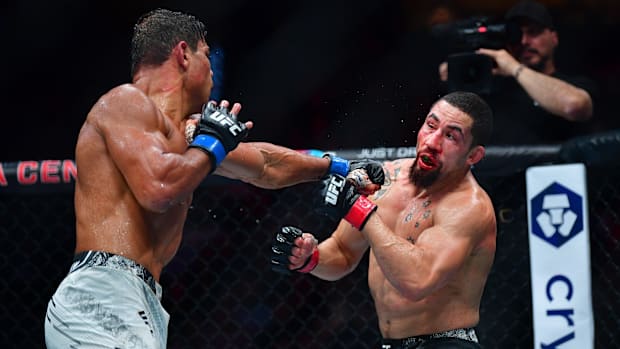 Robert Whittaker fighting Paulo Cost