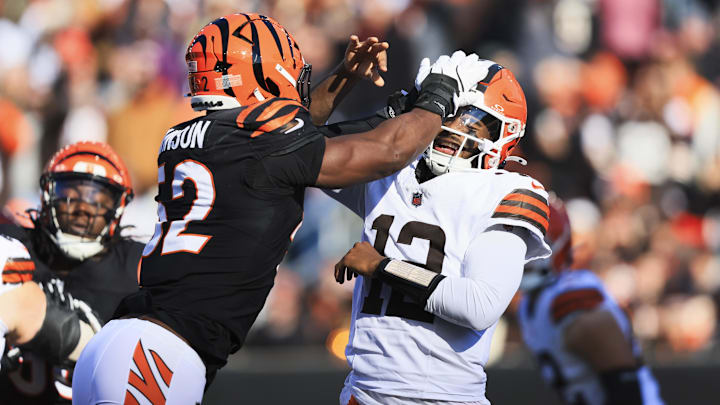 Jan 4, 2026; Cincinnati, Ohio, USA; Cleveland Browns quarterback Shedeur Sanders (12) passes under pressure from Cincinnati Bengals defensive end Cedric Johnson (52) during the second quarter at Paycor Stadium. Mandatory Credit: Katie Stratman-Imagn Images