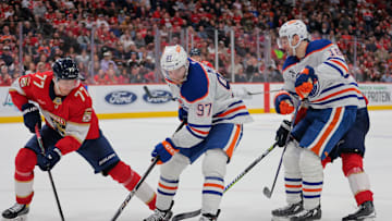 Edmonton Oilers center Connor McDavid (97) moves the puck as Florida Panthers defenseman Niko Mikkola (77)