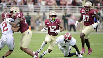 Aug 30, 2025; Tallahassee, Florida, USA; Florida State Seminoles running back Jaylin Lucas (12) runs with the ball against the Alabama Crimson Tide during the first half at Doak S. Campbell Stadium. Mandatory Credit: Melina Myers-Imagn Images