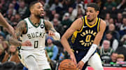 Dec 13, 2023; Milwaukee, Wisconsin, USA; Indiana Pacers guard Tyrese Haliburton (0) passes the ball away from Milwaukee Bucks guard Damian Lillard (0) in the first quarter at Fiserv Forum. Mandatory Credit: Benny Sieu-Imagn Images