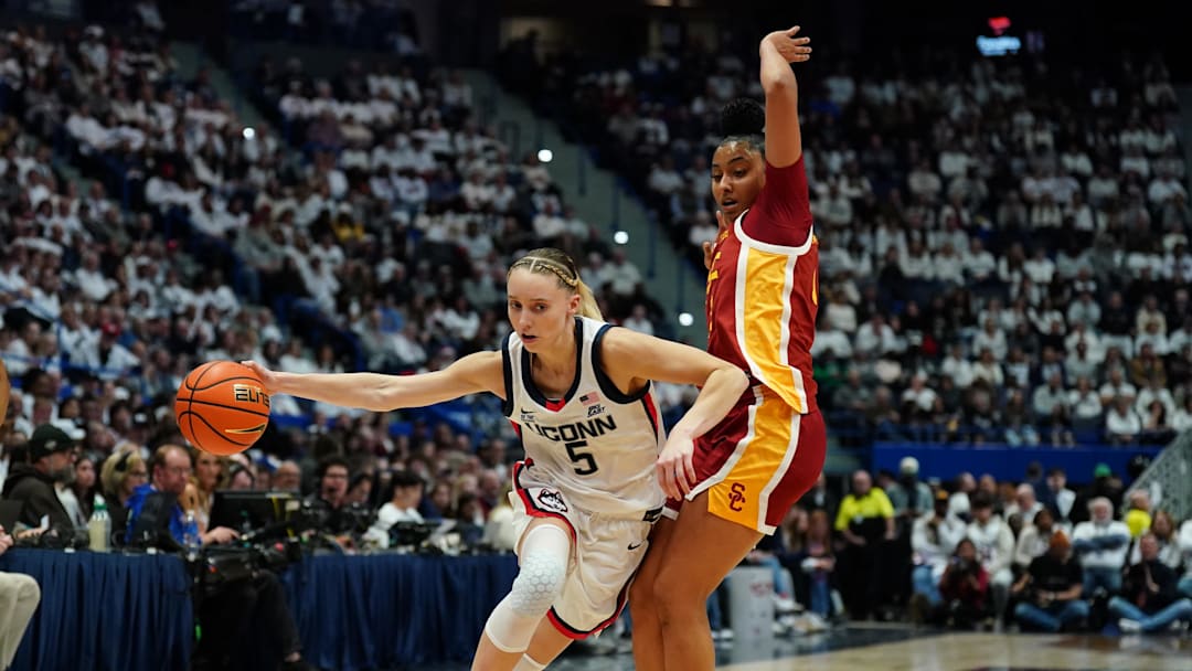 Dec 21, 2024; Hartford, Connecticut, USA; UConn Huskies guard Paige Bueckers (5) drives the ball against USC Trojans guard JuJu Watkins (12) in the first half at XL Center. Mandatory Credit: David Butler II-Imagn Images