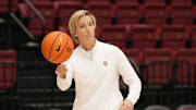 Dec 18, 2022; Stanford, California, USA; Stanford Cardinal associate head coach Kate Paye throws a ball before the game against the Tennessee Lady Vols at Maples Pavilion. Mandatory Credit: Darren Yamashita-Imagn Images