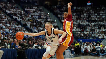 Dec 21, 2024; Hartford, Connecticut, USA; UConn Huskies guard Paige Bueckers (5) drives the ball against USC Trojans guard JuJu Watkins (12) in the first half at XL Center. Mandatory Credit: David Butler II-Imagn Images