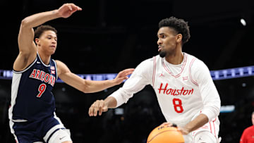 Mar 15, 2025; Kansas City, MO, USA; Houston Cougars guard Mylik Wilson (8) dribbles the ball against Arizona Wildcats forward Carter Bryant (9) during the first half for the Big 12 Conference Tournament Championship game at T-Mobile Center. Mandatory Credit: William Purnell-Imagn Images