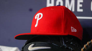 May 26, 2023; Atlanta, Georgia, USA; A detailed view of a Philadelphia Phillies hat and glove on the bench against the Atlanta Braves in the seventh inning at Truist Park. Mandatory Credit: Brett Davis-Imagn Images