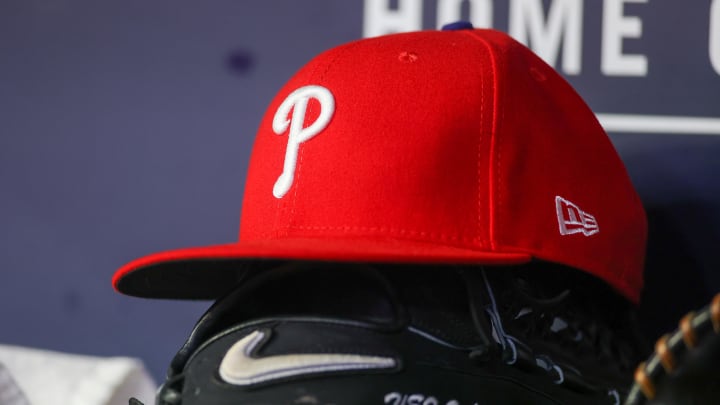 May 26, 2023; Atlanta, Georgia, USA; A detailed view of a Philadelphia Phillies hat and glove on the bench against the Atlanta Braves in the seventh inning at Truist Park.