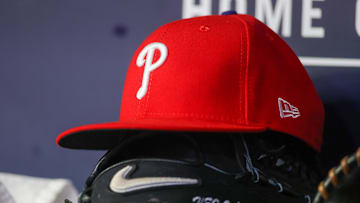 May 26, 2023; Atlanta, Georgia, USA; A detailed view of a Philadelphia Phillies hat and glove on the bench against the Atlanta Braves in the seventh inning at Truist Park. Mandatory Credit: Brett Davis-Imagn Images