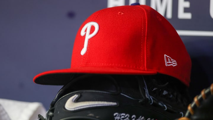 May 26, 2023; Atlanta, Georgia, USA; A detailed view of a Philadelphia Phillies hat and glove on the bench against the Atlanta Braves in the seventh inning at Truist Park