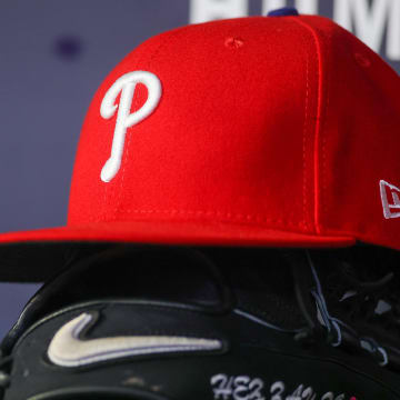 May 26, 2023; Atlanta, Georgia, USA; A Philadelphia Phillies hat and glove on the bench.