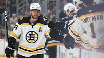 Mar 1, 2025; Pittsburgh, Pennsylvania, USA;  Boston Bruins right wing David Pastrnak (88) celebrates with the Bruins bench after scoring a goal against the Pittsburgh Penguins during the first period at PPG Paints Arena. Mandatory Credit: Charles LeClaire-Imagn Images