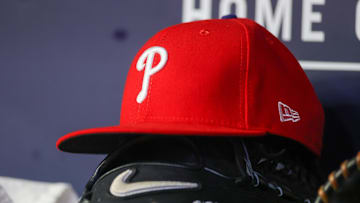 Atlanta, Georgia, USA; A detailed view of a Philadelphia Phillies hat and glove on the bench against the Atlanta Braves in the seventh inning at Truist Park.