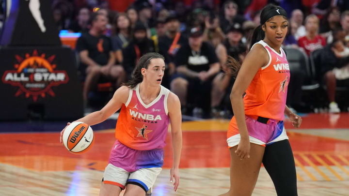 Jul 20, 2024; Phoenix, AZ, USA; Team WNBA guard Caitlin Clark (22) dribbles alongside Team WNBA forward Angel Reese (5) against USA Women's National Team during the WNBA All Star Game at Footprint Center. Mandatory Credit: Joe Camporeale-USA TODAY Sports