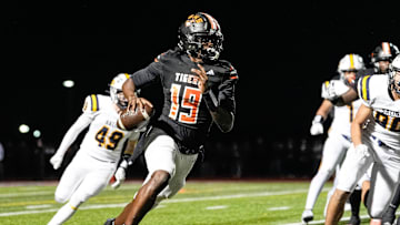 Belleville quarterback Bryce Underwood keeps the ball and runs against Saline during the second half of district final at Belleville High School in Belleville on Friday, Nov. 8, 2024.