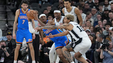 Feb 29, 2024; San Antonio, Texas, USA;  Oklahoma City Thunder guard Shai Gilgeous-Alexander (2) looks to pass against San Antonio Spurs guard Malaki Branham (22) and forward Jeremy Sochan (10) in the first half at Frost Bank Center. Mandatory Credit: Daniel Dunn-Imagn Images