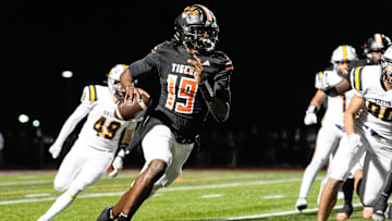 Belleville quarterback Bryce Underwood keeps the ball and runs against Saline during the second half of district final at Belleville High School in Belleville on Friday, Nov. 8, 2024.