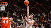 Mar 1, 2025; Blacksburg, Virginia, USA;  Virginia Tech Hokies forward Ben Burnham (13) attempts a shot over Syracuse Orange forward Jyare Davis (13) during the second half at Cassell Coliseum. Mandatory Credit: Brian Bishop-Imagn Images