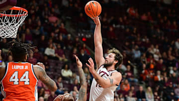 Mar 1, 2025; Blacksburg, Virginia, USA;  Virginia Tech Hokies forward Ben Burnham (13) attempts a shot over Syracuse Orange forward Jyare Davis (13) during the second half at Cassell Coliseum. Mandatory Credit: Brian Bishop-Imagn Images