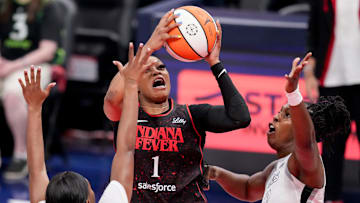 Indiana Fever guard Odyssey Sims (1) is guarded by Las Vegas Aces guard Dana Evans (11) and Las Vegas Aces guard Chelsea Gray (12) on Friday, Sept. 26, 2025, during Game 3 of the WNBA semifinals at Gainbridge Fieldhouse in Indianapolis.