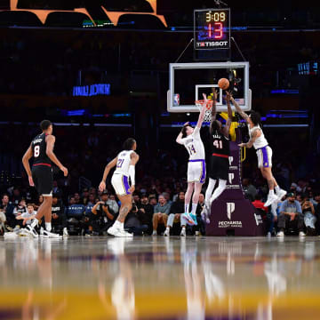 Jan 21, 2024; Los Angeles, California, USA; Portland Trail Blazers center Ibou Badji (41) shoots against Los Angeles Lakers center Colin Castleton (14) and guard Jalen Hood-Schifino (0) during the second half at Crypto.com Arena. Mandatory Credit: Gary A. Vasquez-USA TODAY Sports
