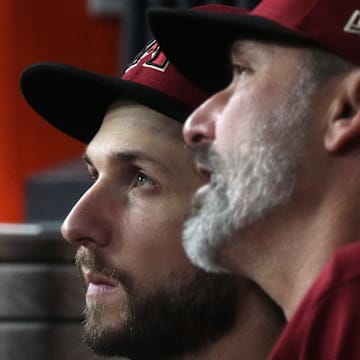 Arizona Diamondbacks starting pitcher Zac Gallen (23) speaks with manager Torey Lovullo (right) in the dugout during the sixth inning against the Texas Rangers in game one of the 2023 World Series at Globe Life Field in Arlington, Texas, on Oct. 27, 2023.