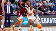 Mar 20, 2025; Denver, CO, USA; Montana Grizzlies guard Money Williams (0) defends against Wisconsin Badgers guard John Blackwell (25) during the second half in the first round of the NCAA Tournament at Ball Arena. Mandatory Credit: Ron Chenoy-Imagn Images