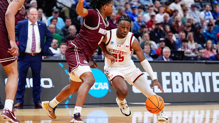 Mar 20, 2025; Denver, CO, USA; Montana Grizzlies guard Money Williams (0) defends against Wisconsin Badgers guard John Blackwell (25) during the second half in the first round of the NCAA Tournament at Ball Arena. Mandatory Credit: Ron Chenoy-Imagn Images Mar 20, 2025; Denver, CO, USA; Montana Grizzlies guard Money Williams (0) defends against Wisconsin Badgers guard John Blackwell (25) during the second half in the first round of the NCAA Tournament at Ball Arena. Mandatory Credit: Ron Chenoy-Imagn Images