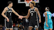 Dec 1, 2025; Brooklyn, New York, USA; Brooklyn Nets guard Egor Demin (8) high fives forward Noah Clowney (21) in front of Charlotte Hornets forward Miles Bridges (0) during the third quarter at Barclays Center. Mandatory Credit: Brad Penner-Imagn Images