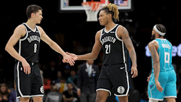 Dec 1, 2025; Brooklyn, New York, USA; Brooklyn Nets guard Egor Demin (8) high fives forward Noah Clowney (21) in front of Charlotte Hornets forward Miles Bridges (0) during the third quarter at Barclays Center. Mandatory Credit: Brad Penner-Imagn Images